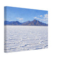 Canvas print of a salt flat landscape with mountains in the background