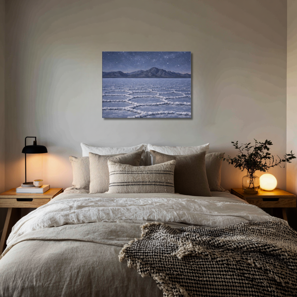 Cozy bedroom with a bed, nightstands, and wall art of a Bonneville Salt Flats at night landscape.