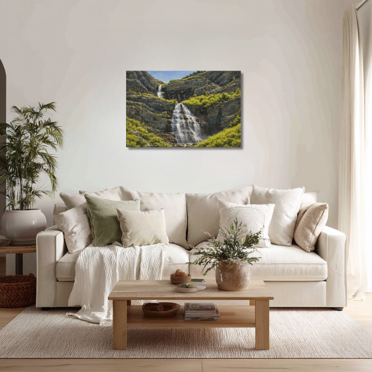 Living room with a white sofa, wooden coffee table, and a wall art of a Bridal Veil Falls.