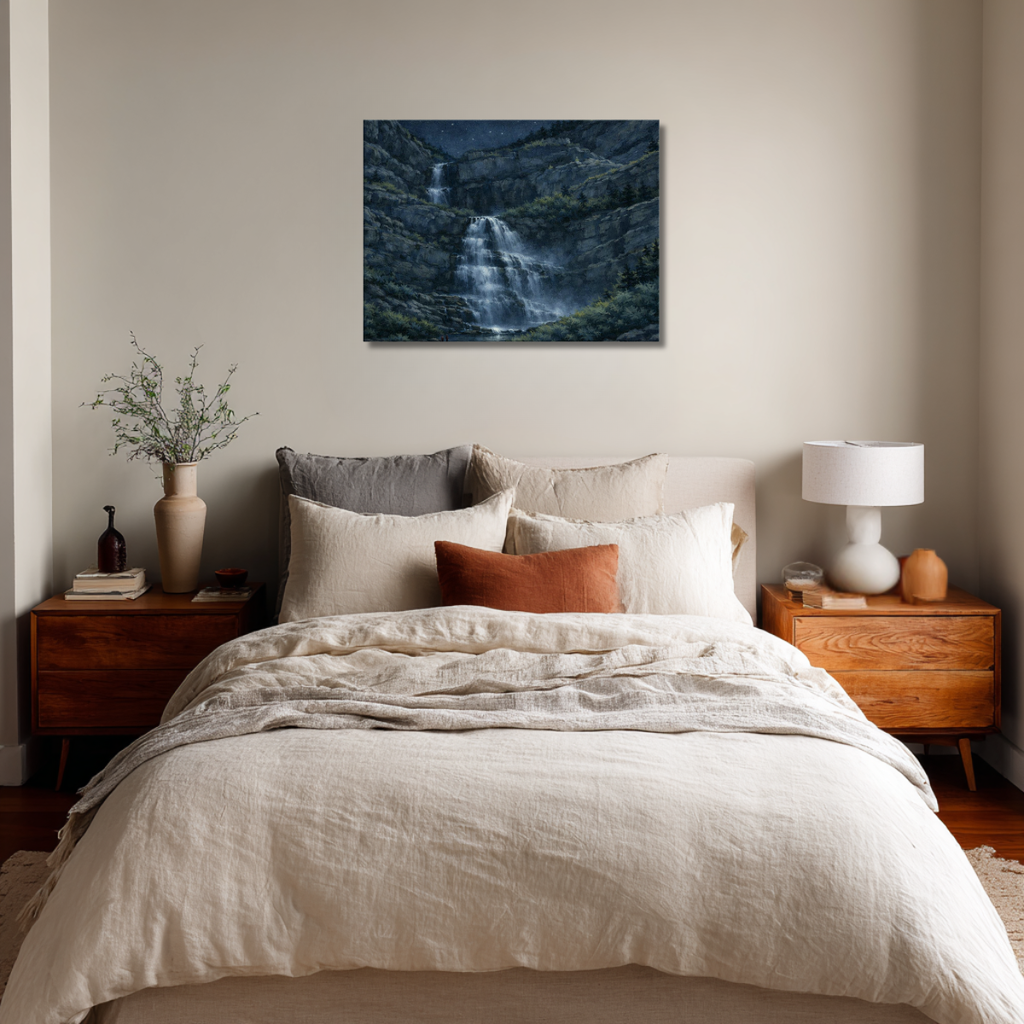 Bedroom with a large bed, nightstands, and a wall art piece of Bridal Veil Falls at night.