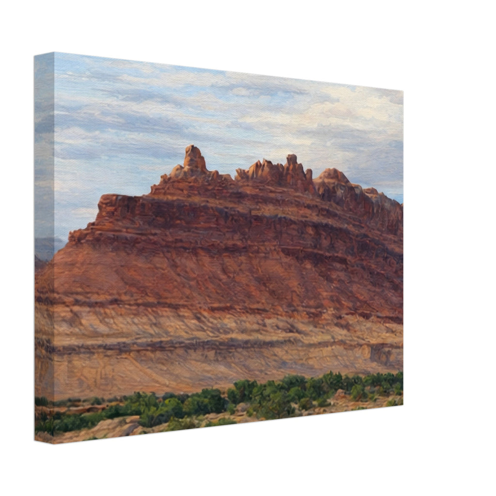 Canvas print of a desert landscape with red rock formations and greenery.