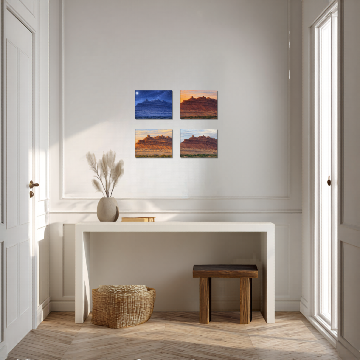 Entryway of modern interior with a console table, decorative items, and four canvas wall art pieces of the Rock Ship formation at Black Dragon Canyon each depicting different times of day. So Nighttime, Sunset, Sunrise, and Daytime.