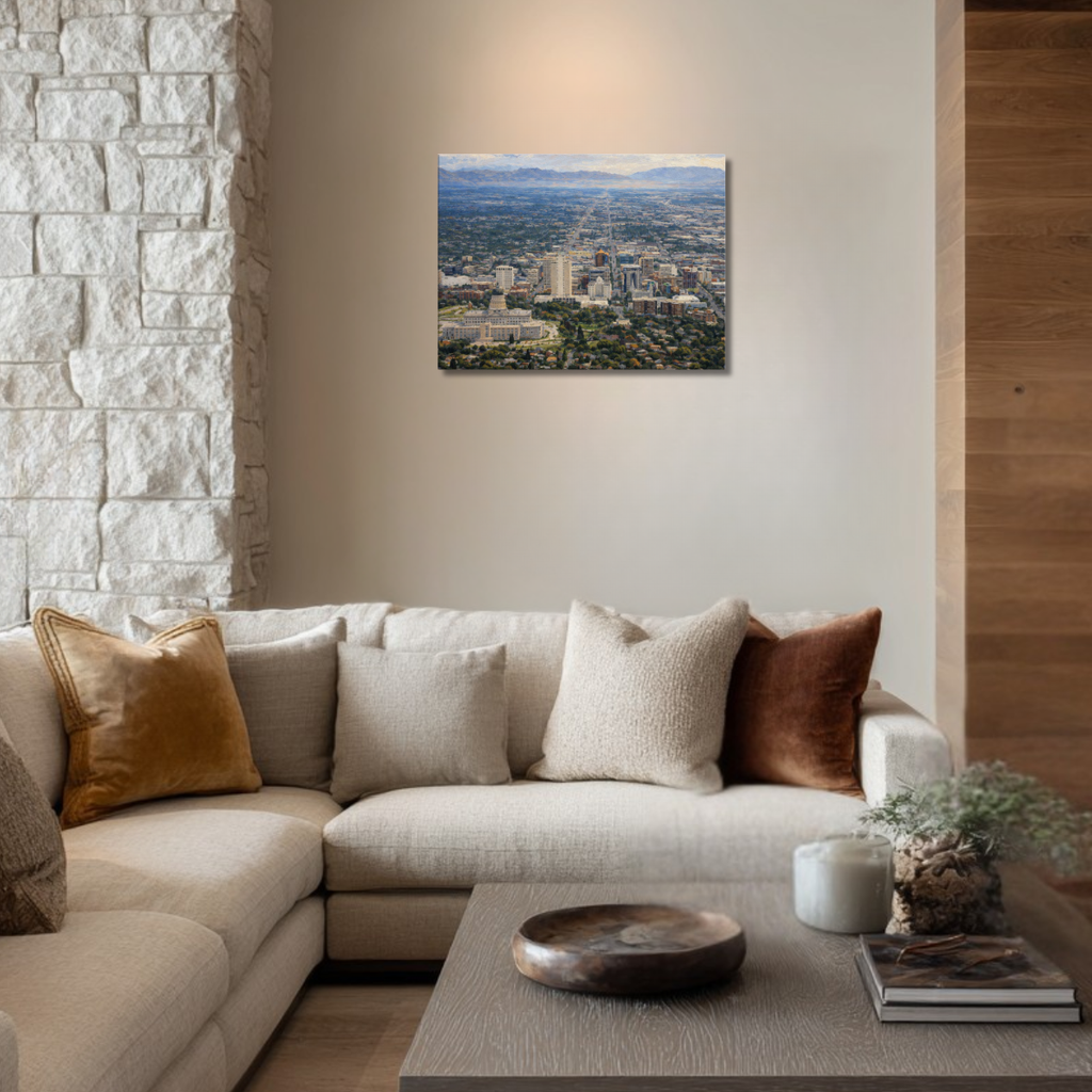 Living room with a sectional sofa, coffee table, and canvas wall art of Salt Lake City Utah hanging on the wall.